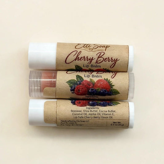 Three tubes of Ellie Sage Cherry Berry lip balm stacked vertically on a light beige background.