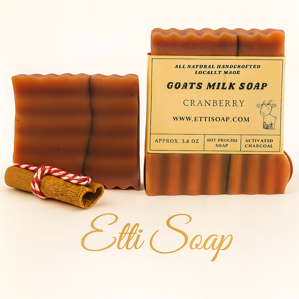 Two bars of goats milk soap with a cinnamon stick on a white background, featuring the brand 'Etti Soap'.