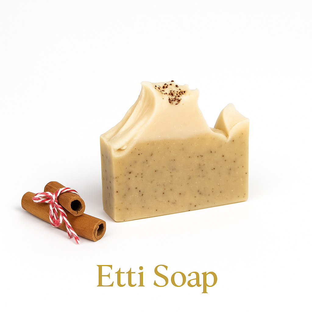 Etti Soap artisan bar featuring poppy seeds and a creamy textured top beside cinnamon sticks on a bright white backdrop