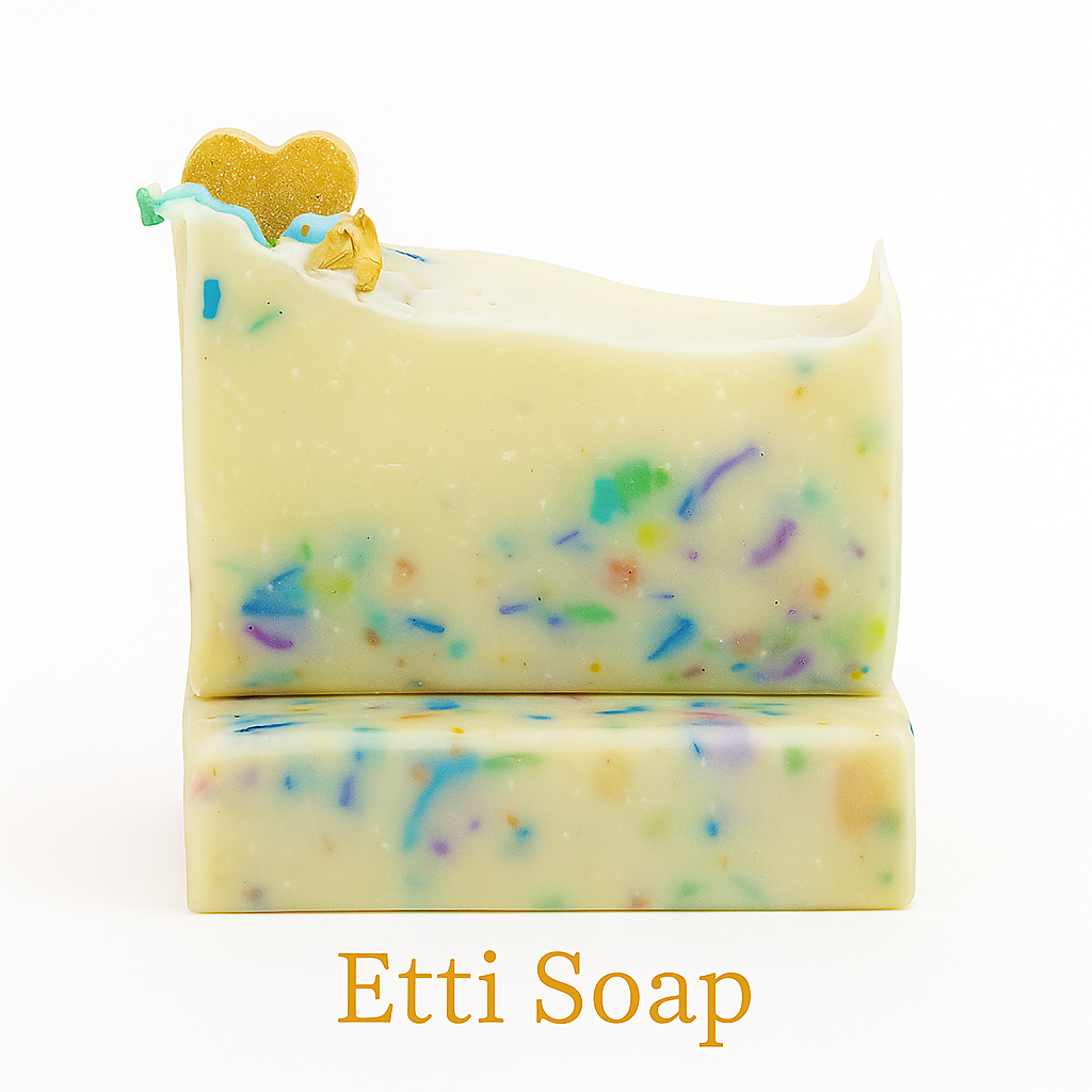 Handcrafted confetti soap bar by Etti Soap with colorful soap shreds, creamy white base, and gold heart accent on top, displayed on a clean white background