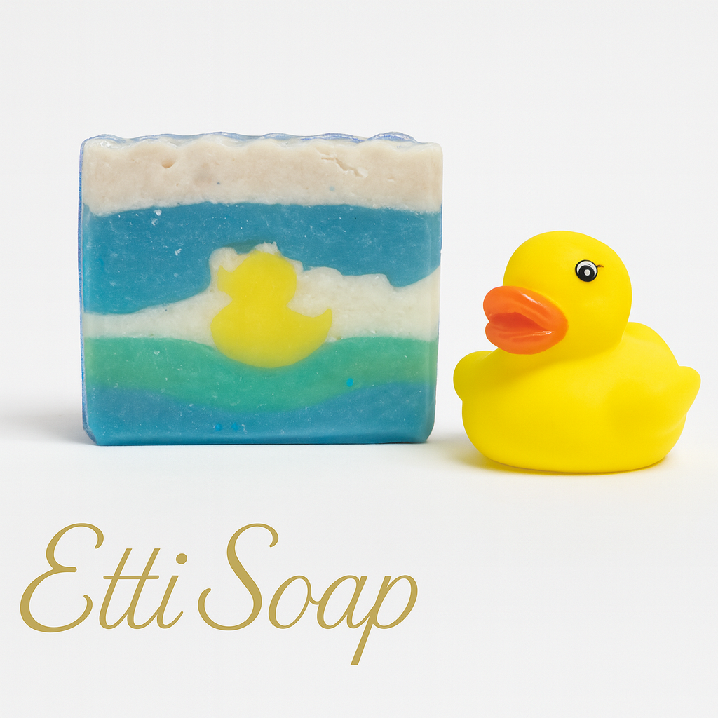 Bar of soap with a duck design and a yellow rubber duck next to it, branded 'Etti Soap'.