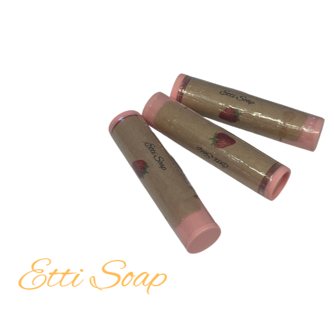 Three cylindrical lip balms with pink caps and visible branding on a white background.