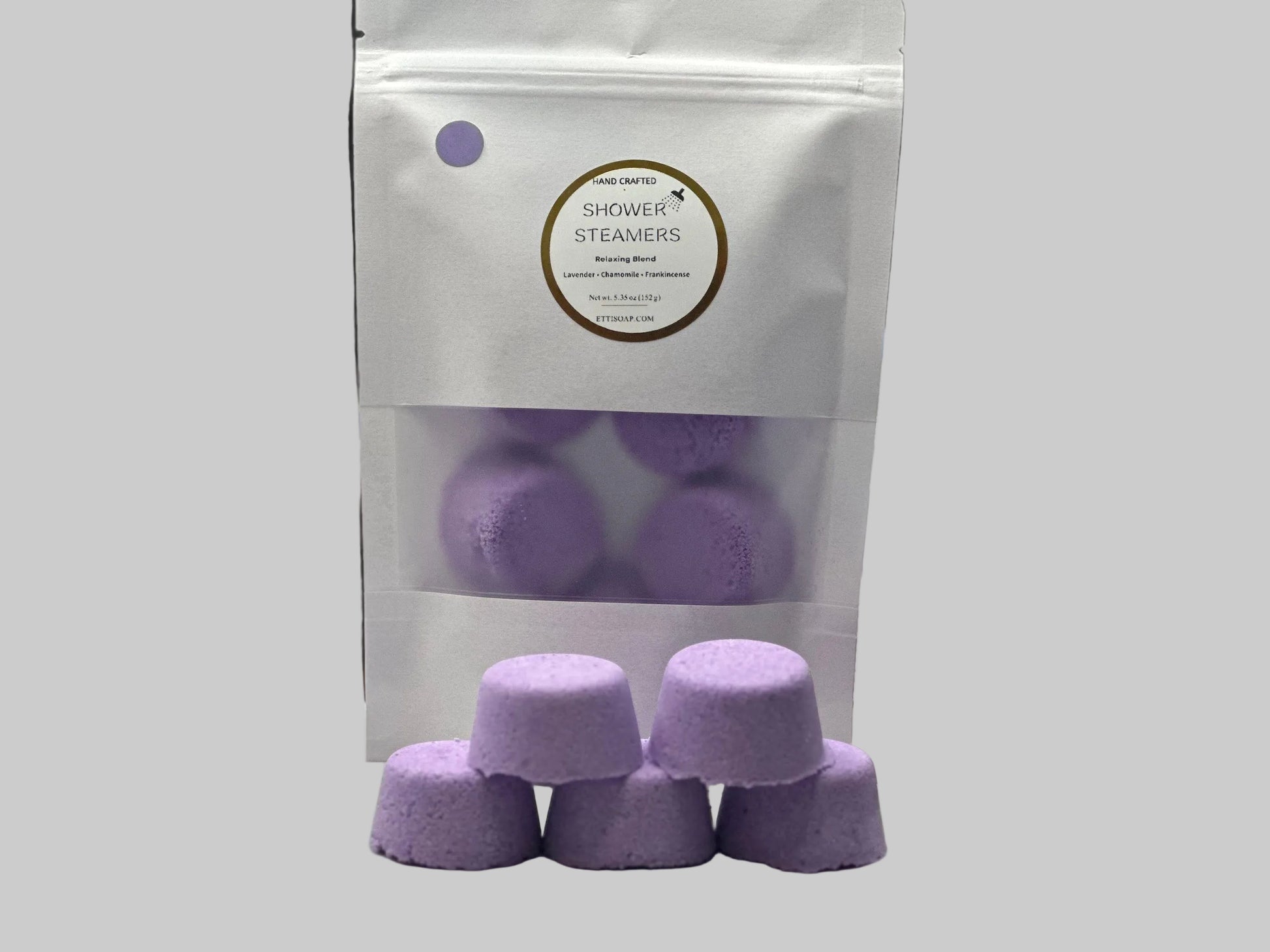 Purple shower steamers with packaging on a table