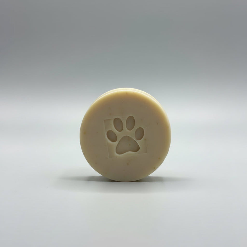 Beige soap bar with a paw print design on a gray background