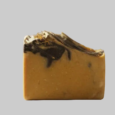 Bar of soap with a marbled design on a white surface