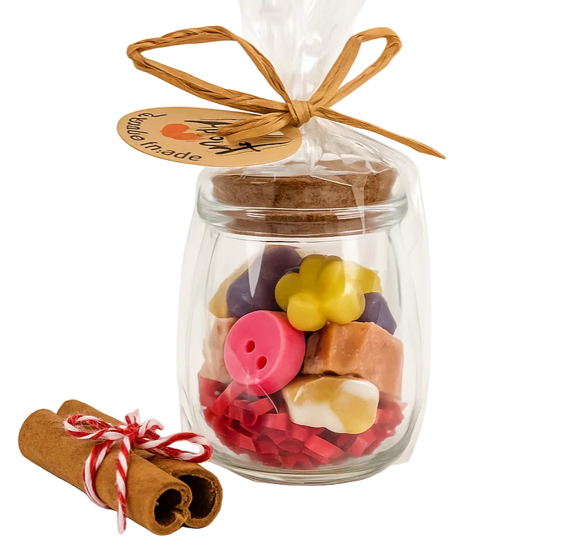 Glass jar filled with colorful buttons, tied with a ribbon, on a white background
